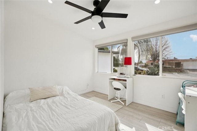 bedroom with ceiling fan and light hardwood / wood-style floors