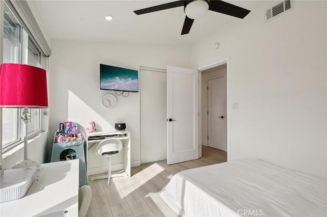 bedroom with vaulted ceiling, ceiling fan, and light hardwood / wood-style flooring