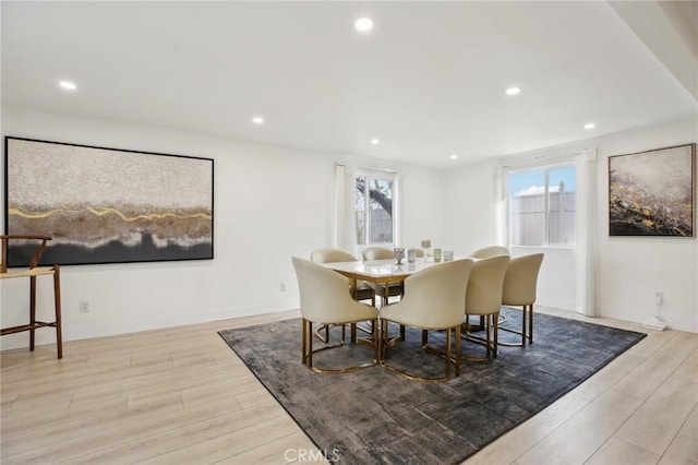 dining space featuring a healthy amount of sunlight and light hardwood / wood-style flooring