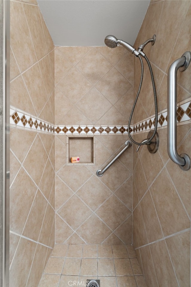 bathroom with a tile shower