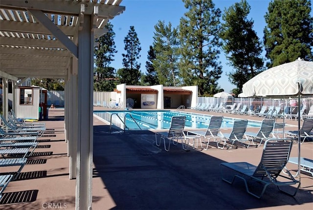 view of swimming pool featuring a patio and a pergola