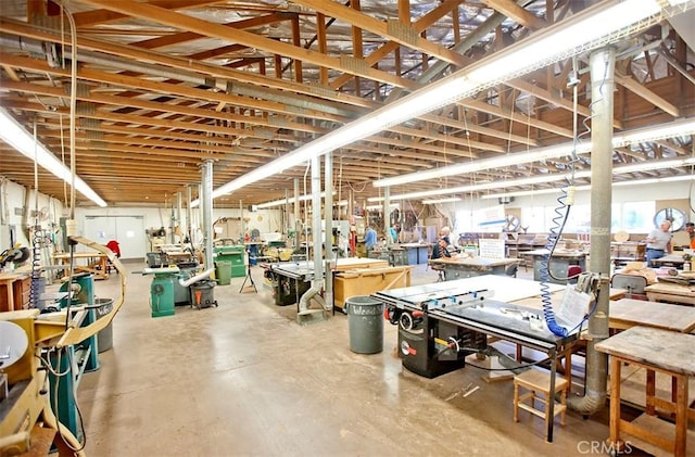 miscellaneous room featuring a workshop area and concrete flooring