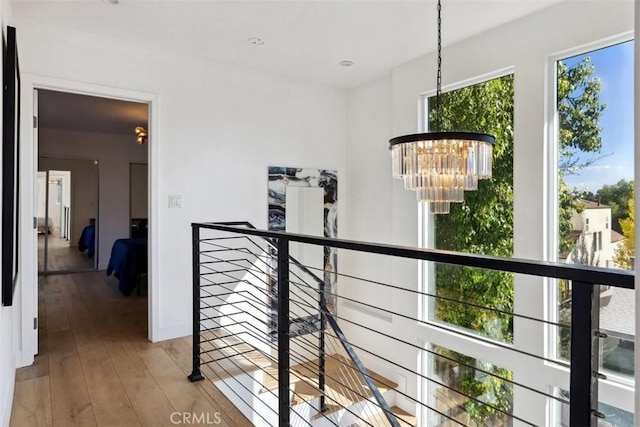 hallway with a chandelier and wood-type flooring