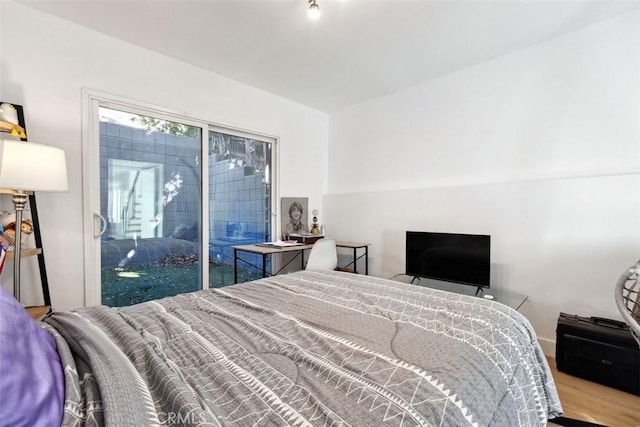 bedroom with hardwood / wood-style flooring