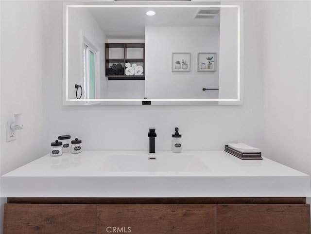 bathroom with visible vents and vanity