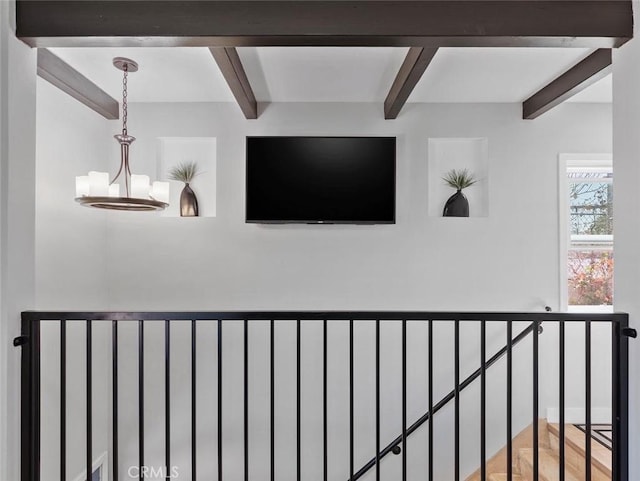 details with beam ceiling and an inviting chandelier