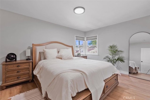 bedroom with light wood-style flooring and baseboards