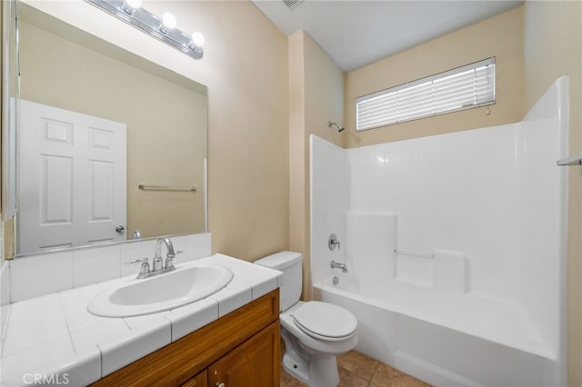 full bathroom with toilet, vanity, tile patterned flooring, and shower / bath combination