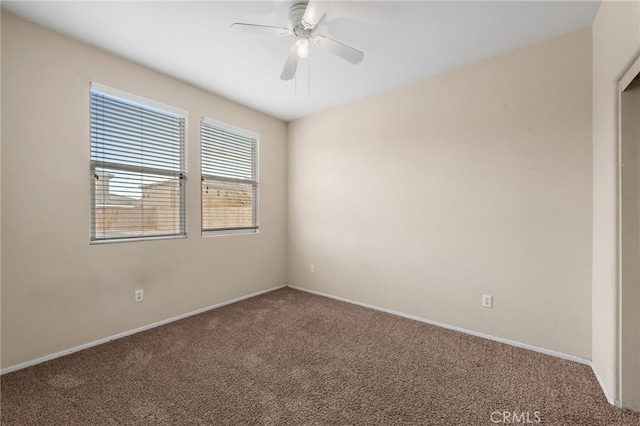 carpeted empty room featuring ceiling fan