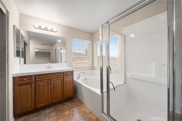 bathroom with vanity, tile patterned flooring, and shower with separate bathtub