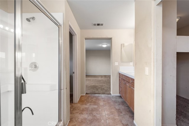 bathroom featuring vanity, tile patterned flooring, and an enclosed shower