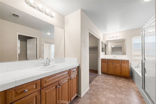 bathroom featuring separate shower and tub and vanity