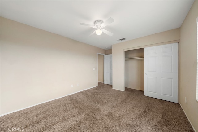 unfurnished bedroom with a closet, ceiling fan, and carpet flooring