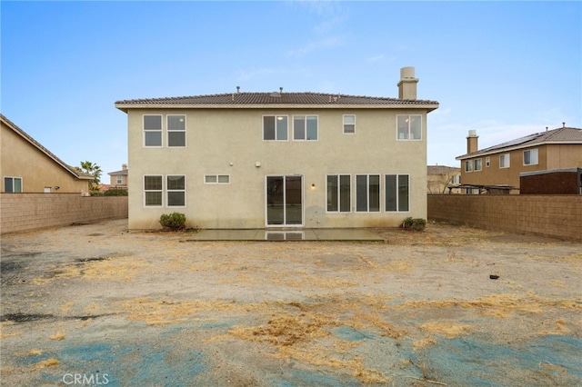 back of house with a patio