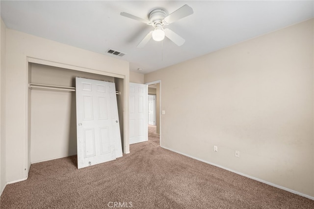 unfurnished bedroom with ceiling fan, carpet flooring, and a closet