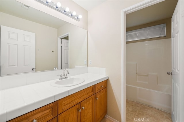 bathroom with shower / bathing tub combination, vanity, and tile patterned floors