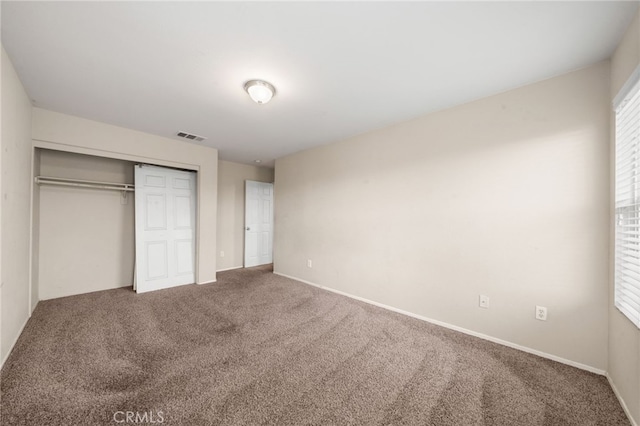 unfurnished bedroom featuring a closet and carpet floors