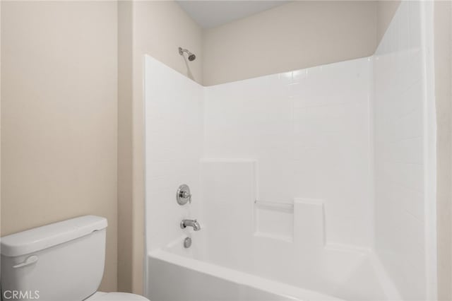 bathroom featuring bathtub / shower combination and toilet