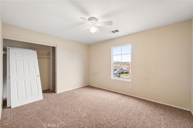 unfurnished bedroom featuring a closet, ceiling fan, and carpet flooring