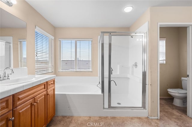 full bathroom featuring plus walk in shower, vanity, tile patterned flooring, and toilet