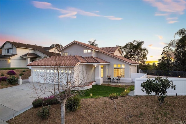 mediterranean / spanish-style house with a garage