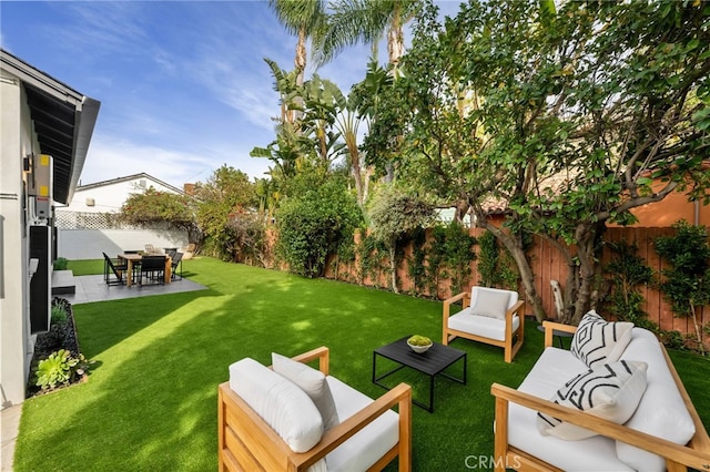 view of yard featuring an outdoor hangout area, a patio area, and a fenced backyard