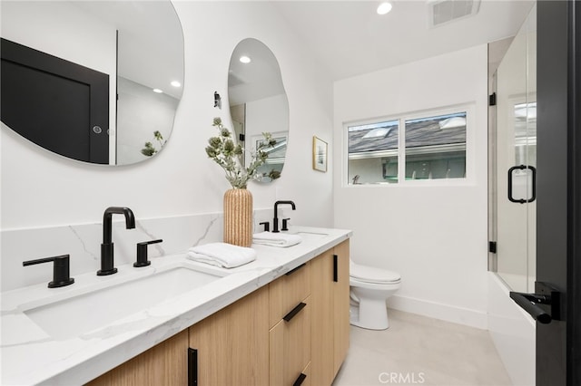 full bathroom featuring toilet, an enclosed shower, a sink, and visible vents