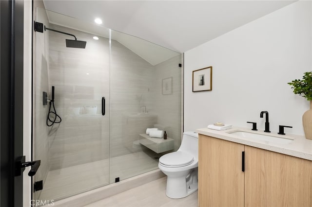 full bath featuring vaulted ceiling, vanity, toilet, and a shower stall