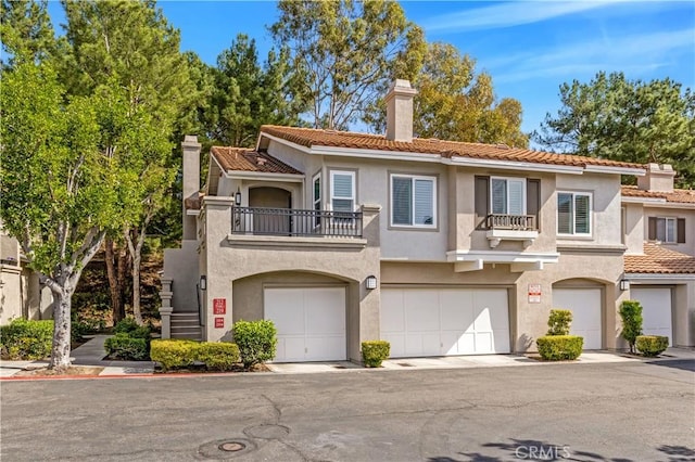 view of front of property with a garage and a balcony