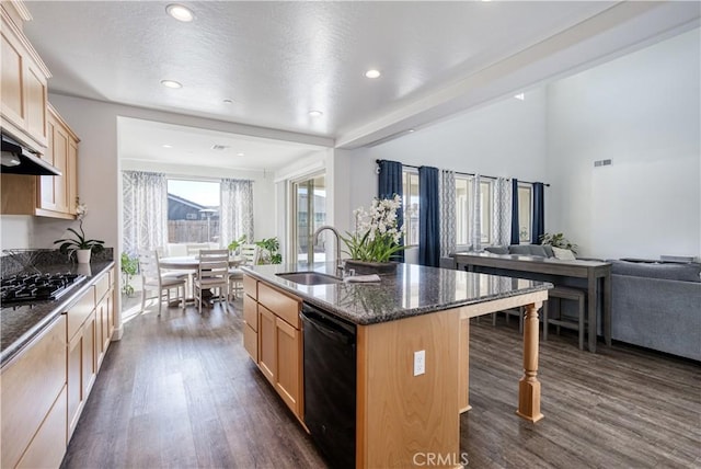 kitchen featuring dishwasher, an island with sink, stainless steel gas cooktop, light brown cabinets, and sink