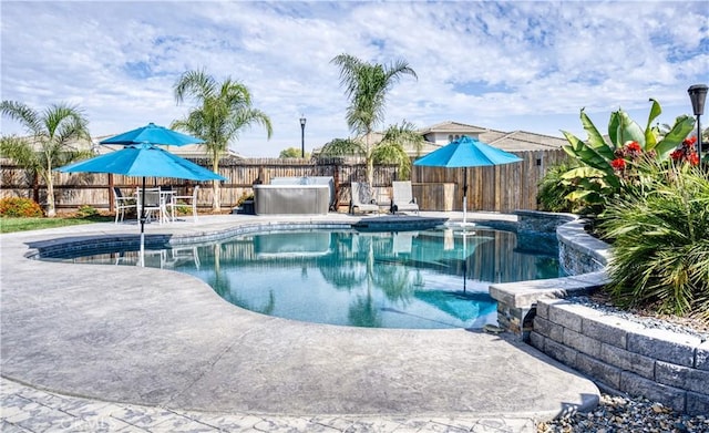 view of swimming pool with a patio area and a jacuzzi