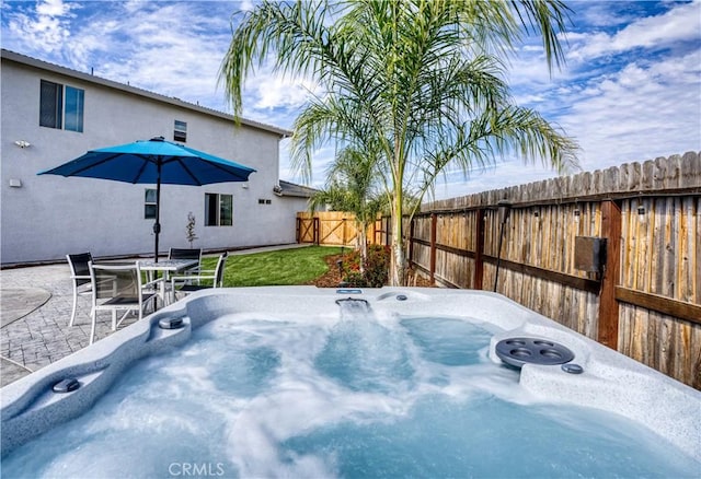 view of patio / terrace with a hot tub