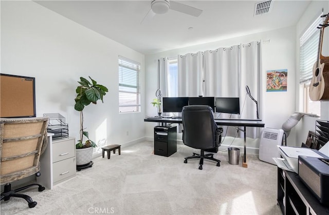 office space featuring light carpet and ceiling fan