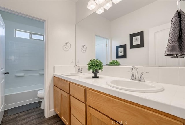 full bathroom featuring vanity, shower / tub combination, toilet, and hardwood / wood-style floors