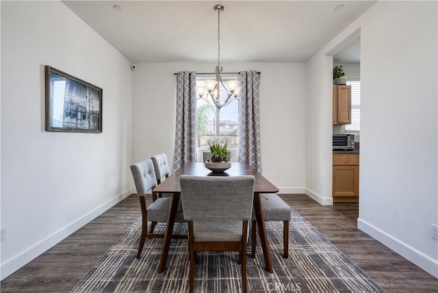 dining room with a chandelier and dark hardwood / wood-style flooring