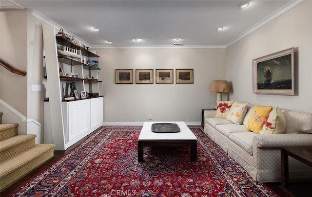 living room featuring ornamental molding, visible vents, baseboards, and stairs