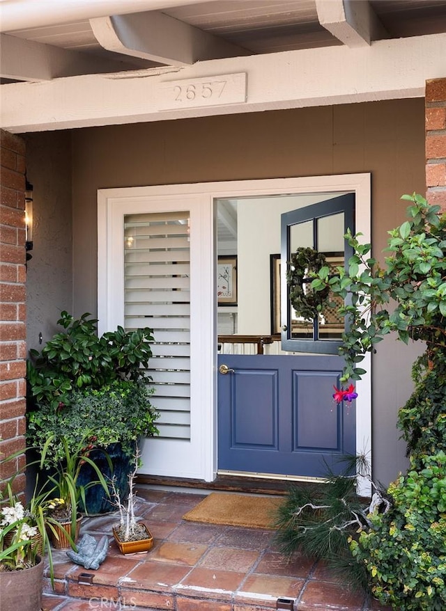 doorway to property with brick siding