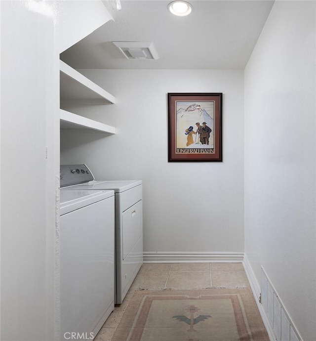 laundry room with light tile patterned floors, laundry area, washer and clothes dryer, and visible vents