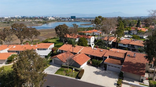 drone / aerial view with a residential view and a water view