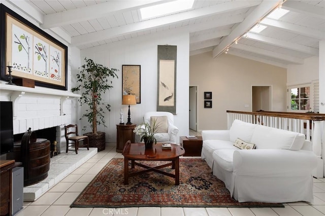 interior space with light tile patterned floors, lofted ceiling with skylight, and a fireplace