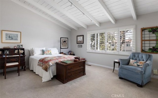 bedroom with vaulted ceiling with beams, light colored carpet, and baseboards