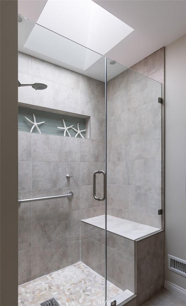 bathroom with visible vents and a shower stall