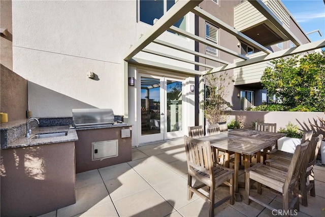 view of patio featuring exterior kitchen, sink, french doors, and area for grilling