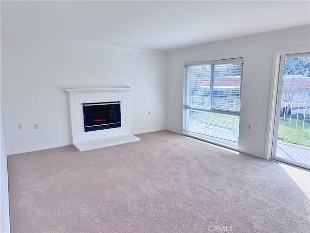 unfurnished living room featuring light carpet, ornamental molding, and a fireplace