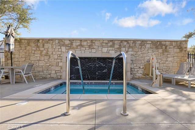 view of swimming pool featuring a swimming pool and a patio