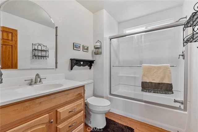 1707 Twin Lakes Dr, Wrightwood, CA 92397 - bathroom featuring wood finished floors, vanity, toilet, and bath / shower combo with glass door