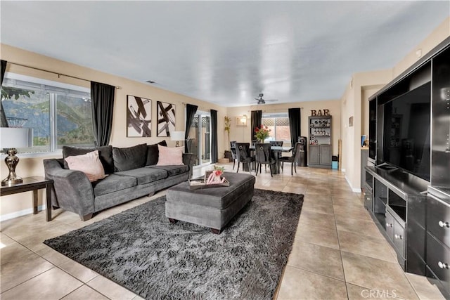 living room with visible vents, baseboards, and light tile patterned floors