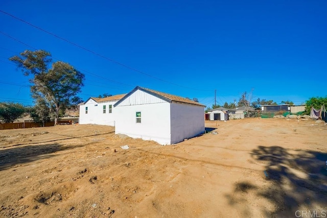 view of home's exterior featuring fence