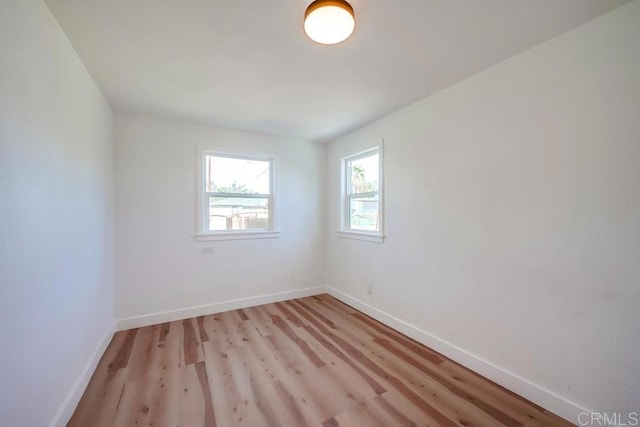 unfurnished room featuring light wood-style flooring and baseboards