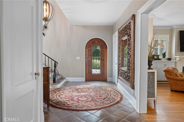 1205 W Highland Ave, Redlands, CA 92373 - foyer featuring healthy amount of natural light, arched walkways, stairway, and baseboards